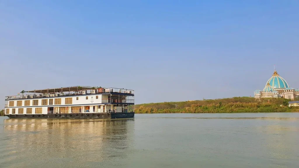 The Rajmahal boat against the Iskcon temple in the backdrop